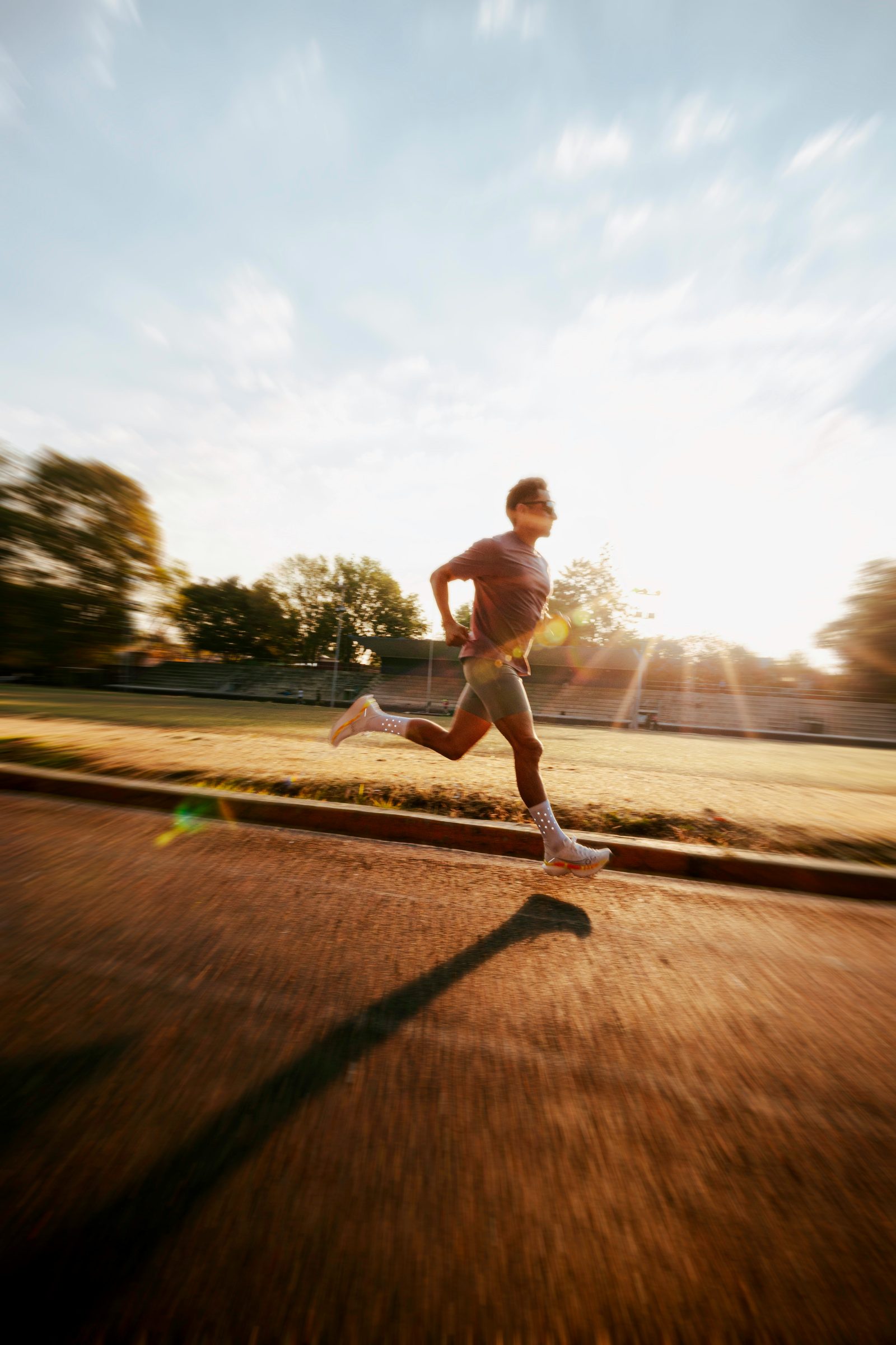 Runner on a track at sunrise